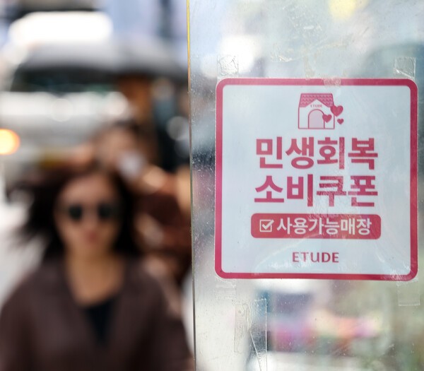  명동의 한 상점 출입문에 민생회복 소비쿠폰 사용 가능 매장을 알리는 안내문이 붙어 있다. 사진=뉴시스